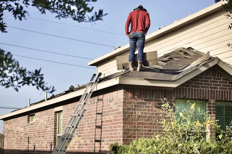 Professional roofer working on a residential roof in Beachwood